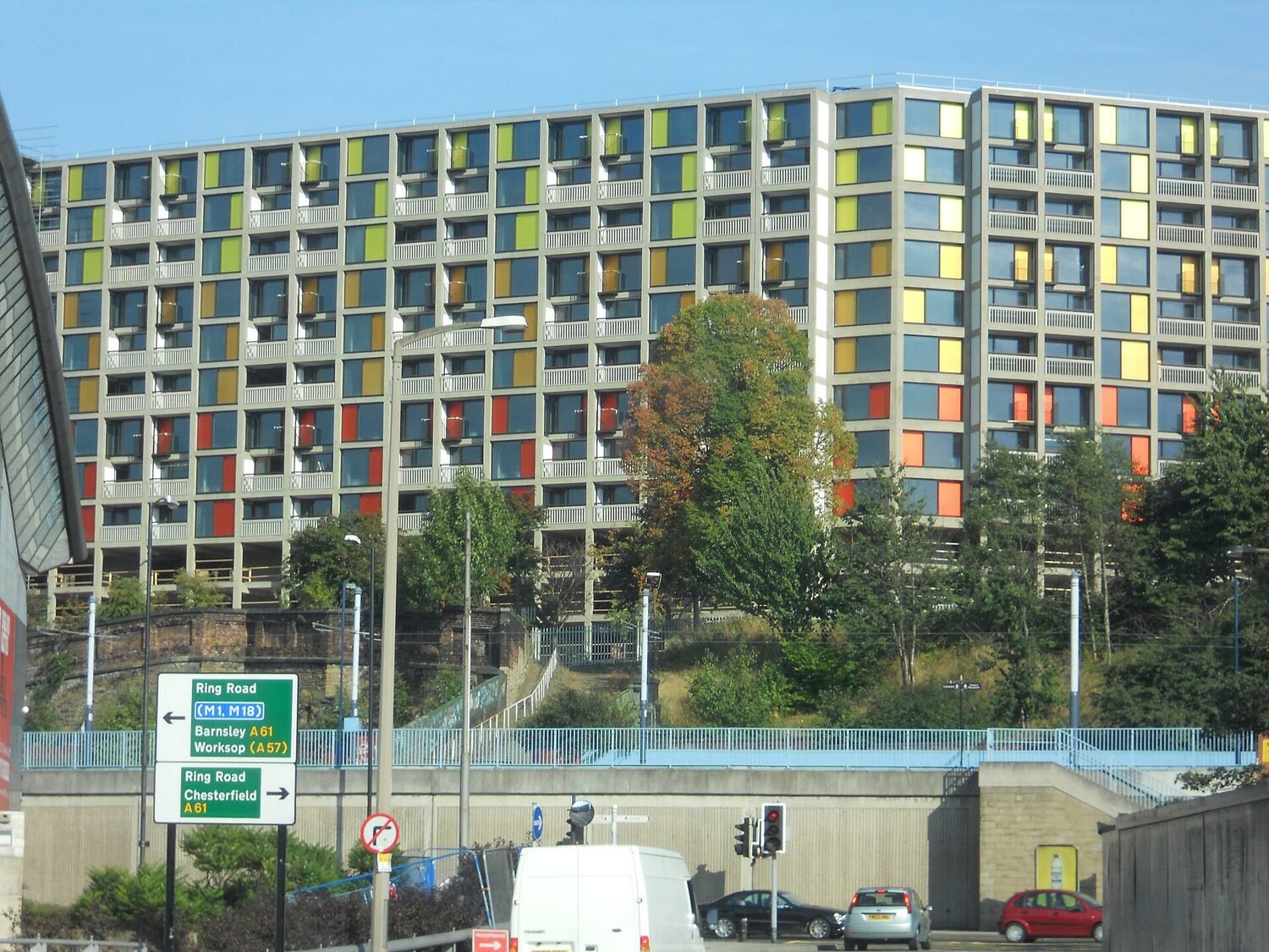 Apartment facade with coloured panels and balconies